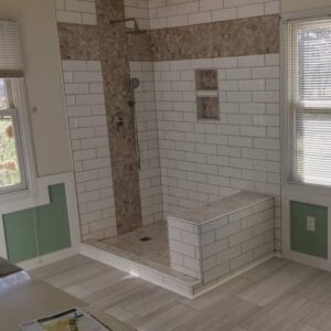 Contemporary bathroom showcasing a walk-in shower with contrasting white subway and textured brown tiles.