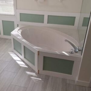 Contemporary bathroom featuring a corner garden tub with white and seafoam green custom tile surround.